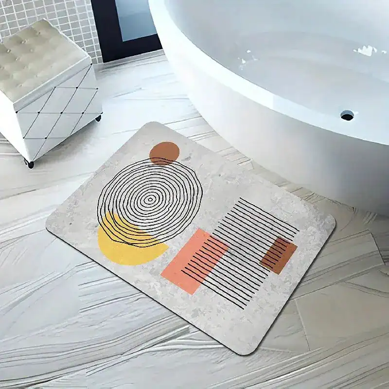 Absorberende badmat met geometrisch patroon in beige, geel en roze, voor badkamer.