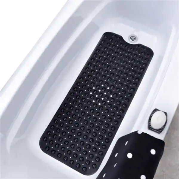 Zwarte antislip badmat met bolletjes in witte badkuip.