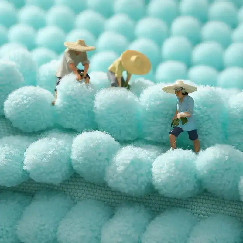 Aqua badmat met antislip textuur, lichtblauw, met miniaturisten op de oppervlakte.
