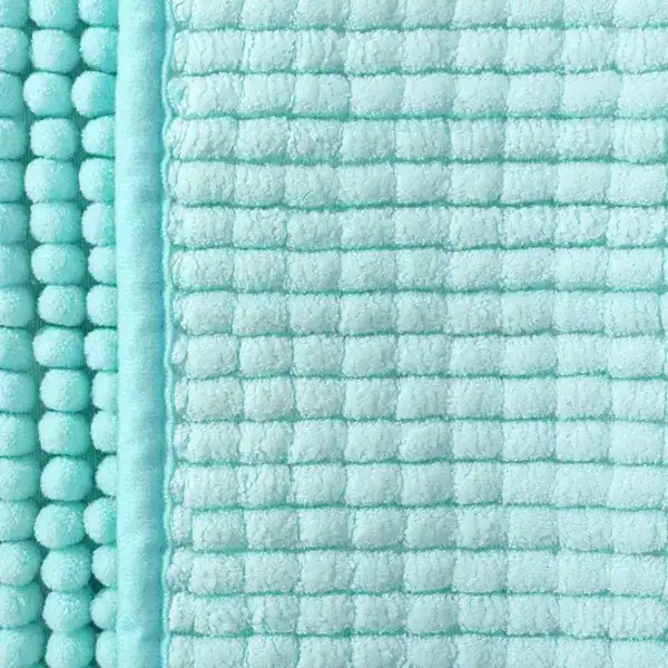 Aqua badmat met pomponrand en geribd oppervlak, antislip badkamermat.