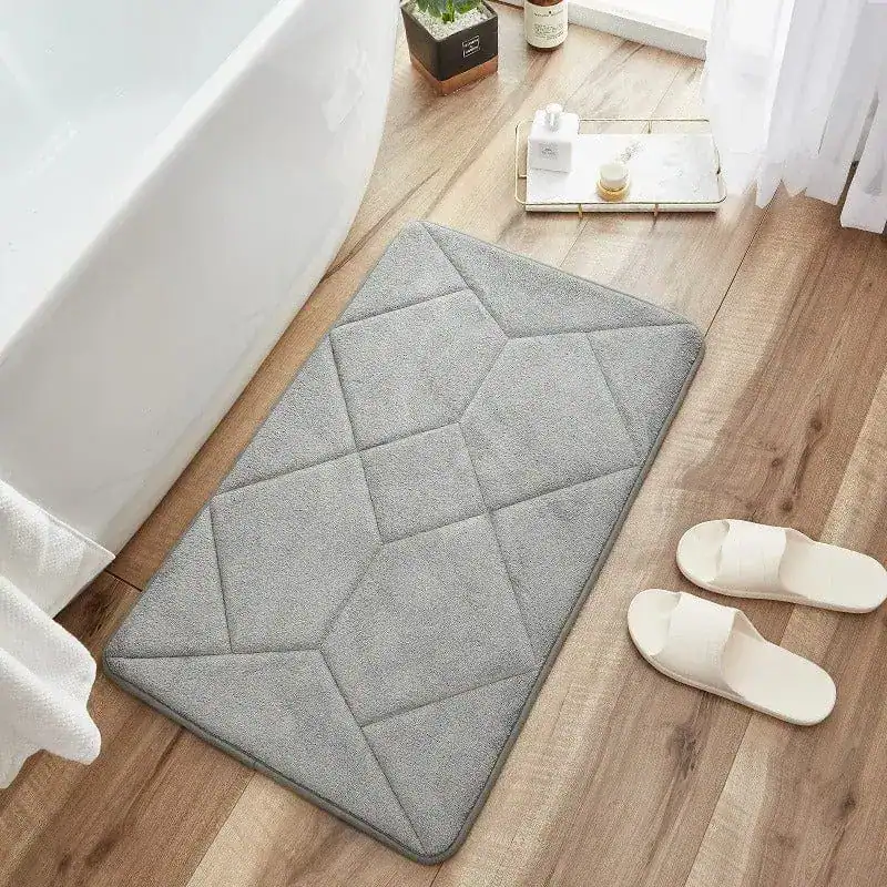 Beige antislip badmat met geometrisch patroon voor badkamer.