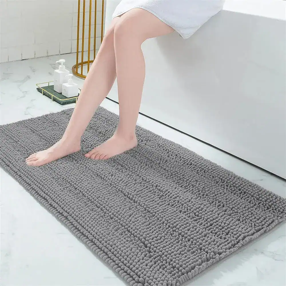Grijze badmat met antislip textuur in de badkamer.