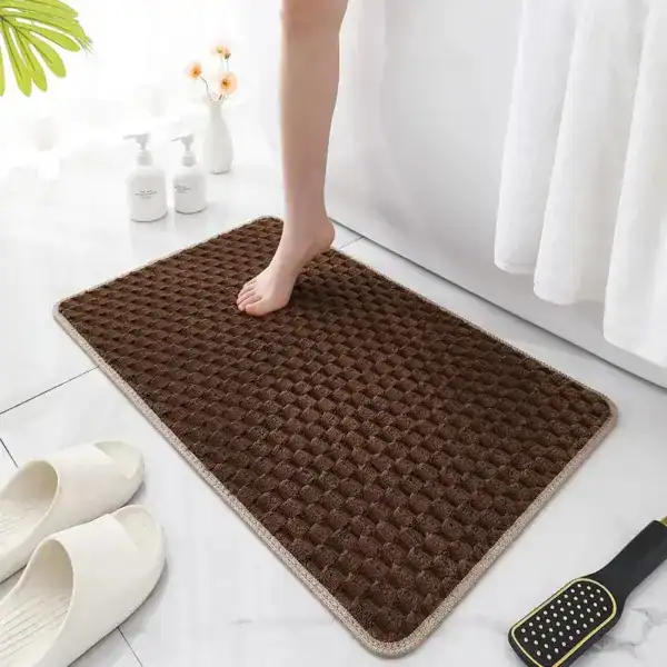 Donkerbruine badmat met antislip textuur in badkamer.