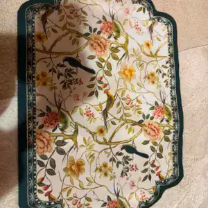 Badmat met bloemen- en vogelprint op een lichte badkamervloer