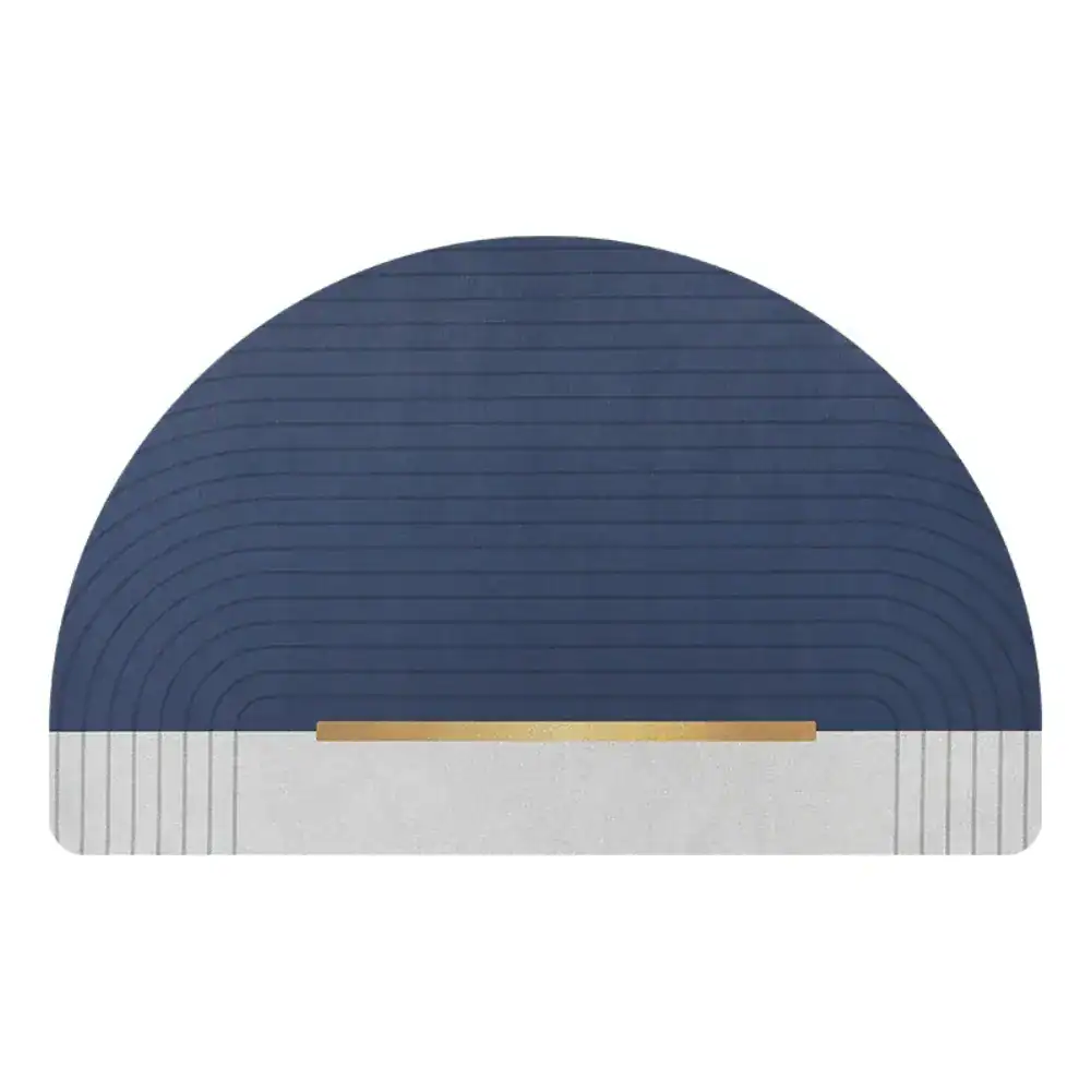 Ronde badmat in blauw met goudkleurige accentstrook en gestreepte textuur.