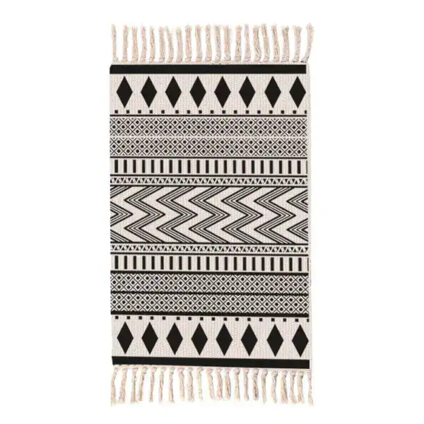 Berber badmat met zwart-wit geometrisch patroon en franje.