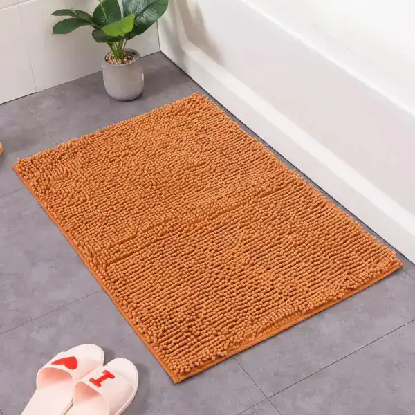 Oranje chenille badmat 60x90 voor badkamer, antislip en comfortabel.