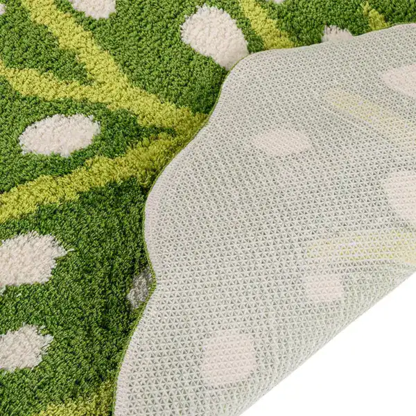 Groene badmat met witte stippen en antislip onderkant.