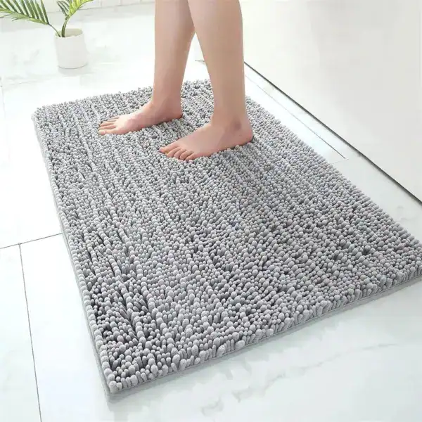 Grijze hoogpolige badmat met antislip effect in de badkamer.