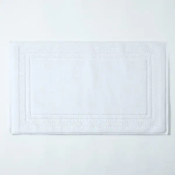 Witte katoen badmat met geborduurde rand, antislip badkamermat.