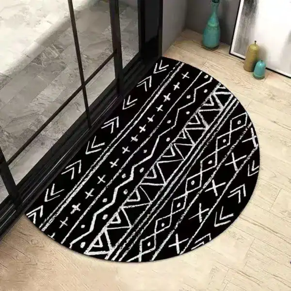 Ronde badmat zwart met witte geometrische patronen, antislip voor badkamer.